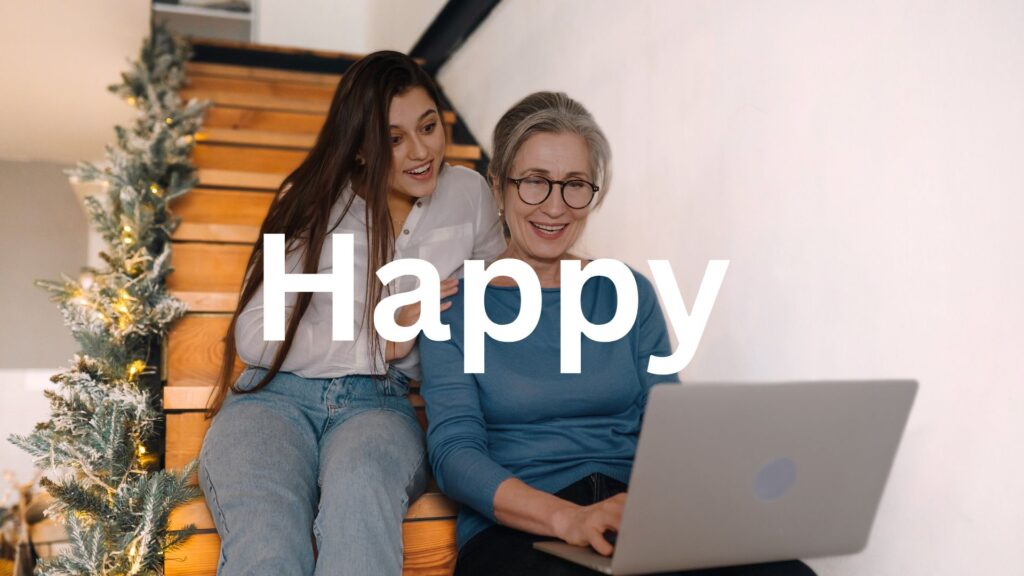 Mother and daughter sitting on the steps and watching something on laptop