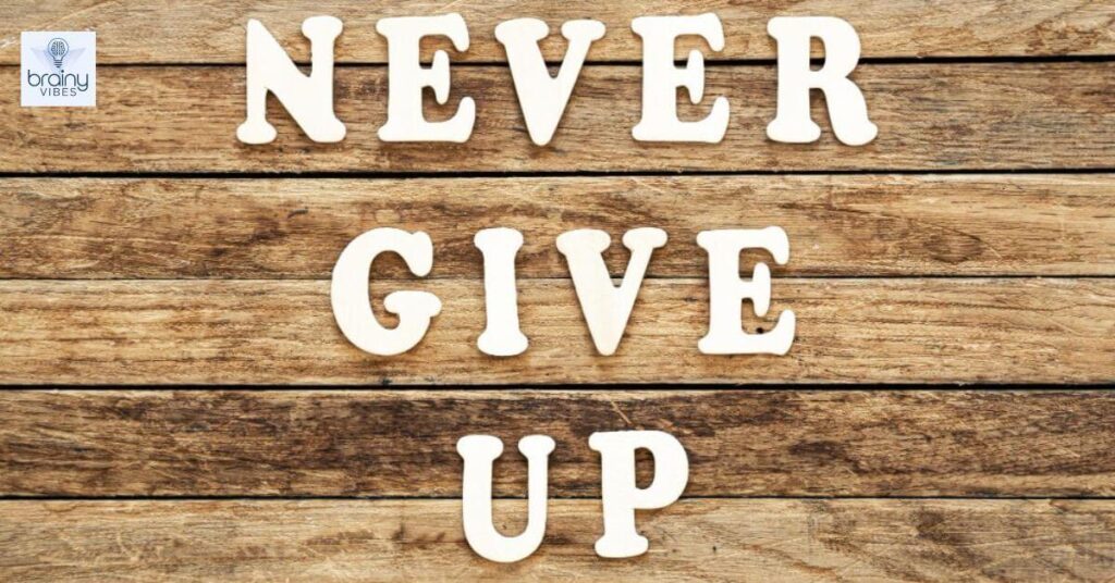 Never give up words made of wooden letters on a wooden background